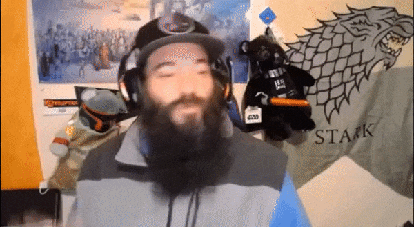 Bearded man with headset streaming in front of Star Wars and House Stark decor.