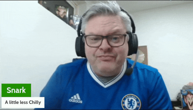 A man wearing a blue Chelsea football shirt and a gaming headset during a livestream.