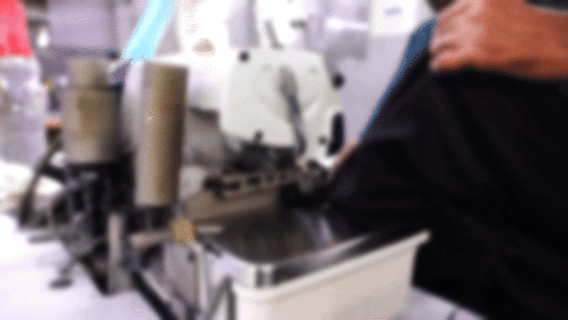 an abstract photo of a curved building with a blue sky in the background