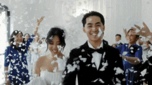 a bride and groom walking on a hill