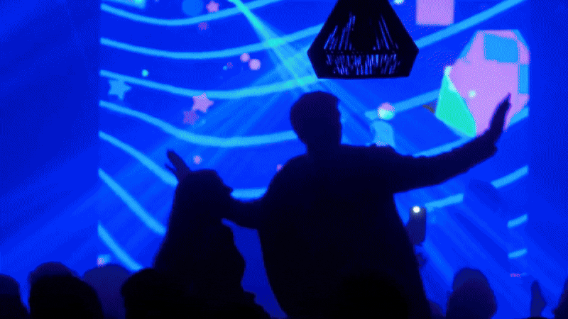 an abstract photo of a curved building with a blue sky in the background