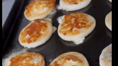 an abstract photo of a curved building with a blue sky in the background