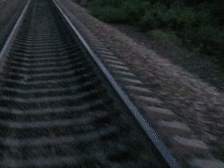 an abstract photo of a curved building with a blue sky in the background