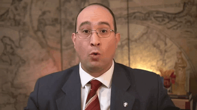 an abstract photo of a curved building with a blue sky in the background