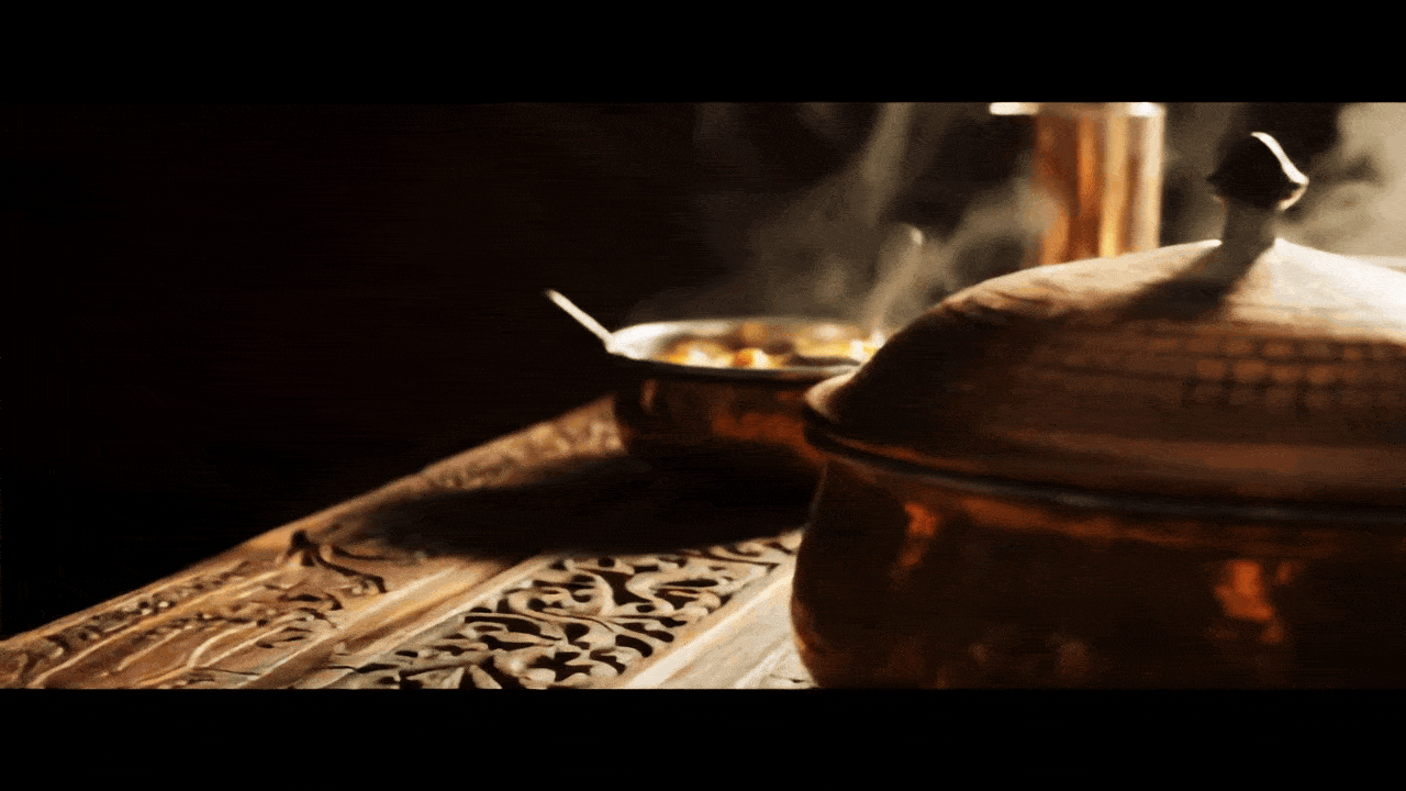 person writing on brown wooden table near white ceramic mug