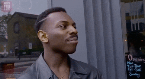 GIF black guy with a fade pointing finder on the side of head saying he is smart