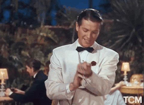 GIF man on suit doing let's start gesture