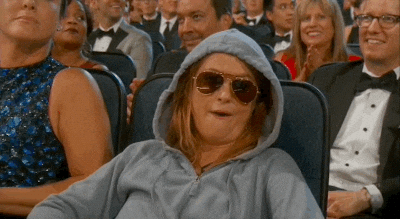 GIF at the award show in hoodie and glasses