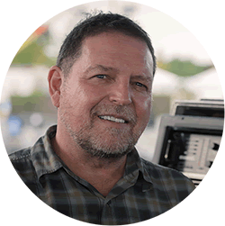 Jon Lemon smiling with an FX rack behind him