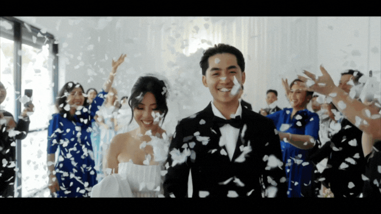 a bride and groom walking on a hill
