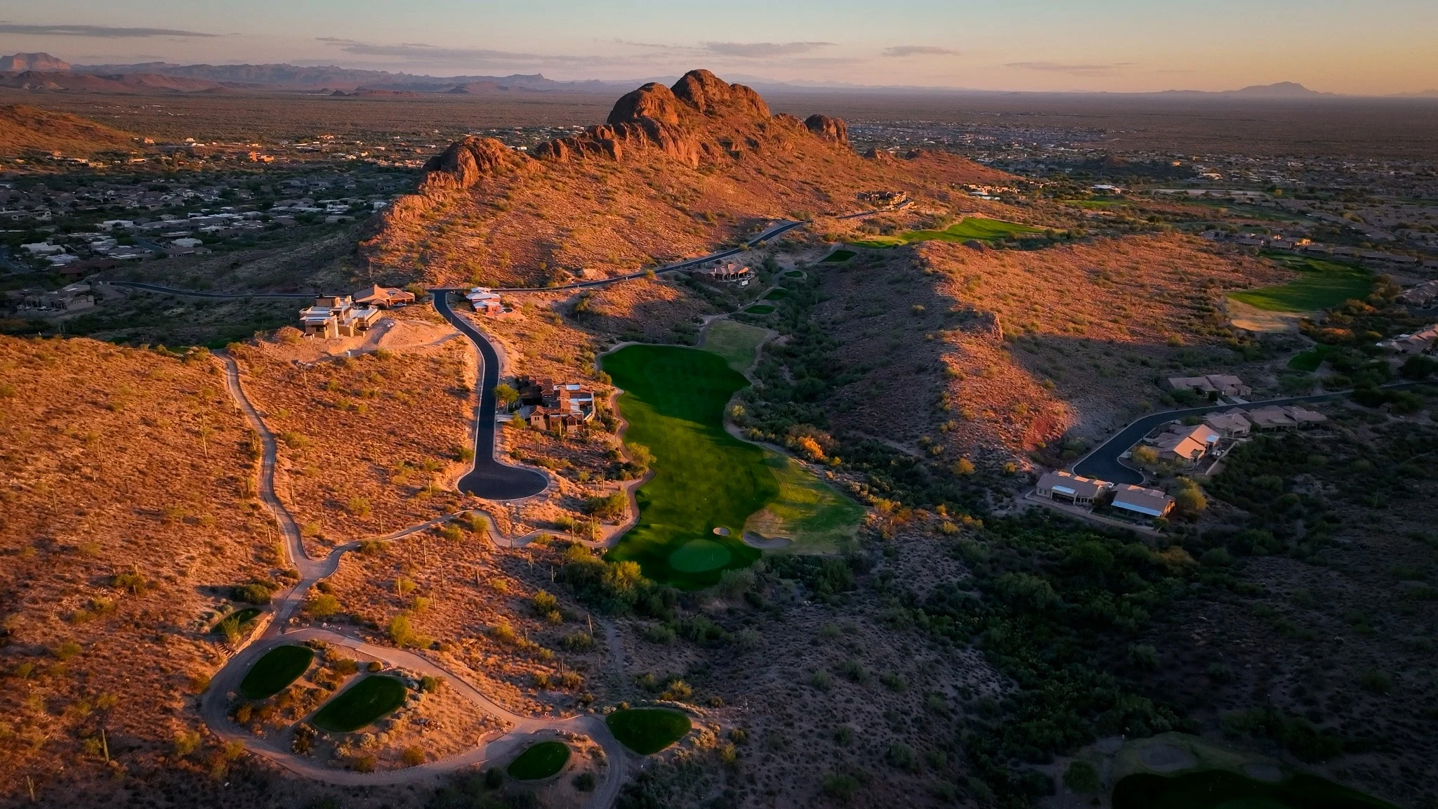 Dinosaur Mountain golf course at sunrise with lava rock and mountain backdrop