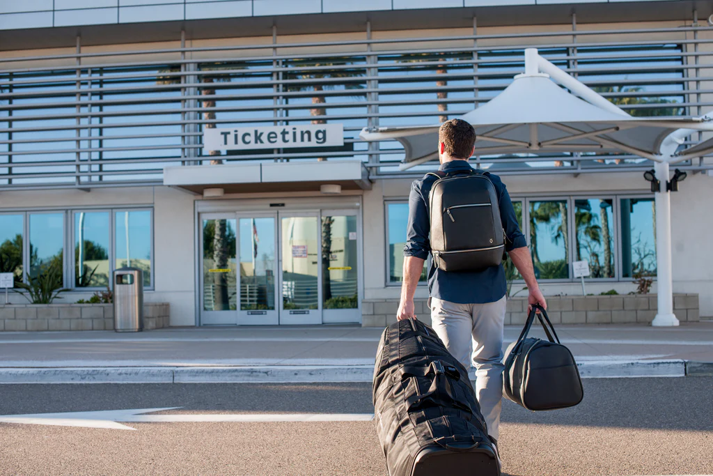 Oceanfront golf course with travel bag at sunset