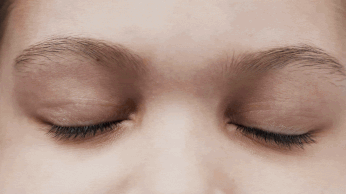 A close up of a person's eye with a keyboard in the background