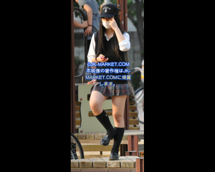 a woman in a school uniform is talking on her cell phone