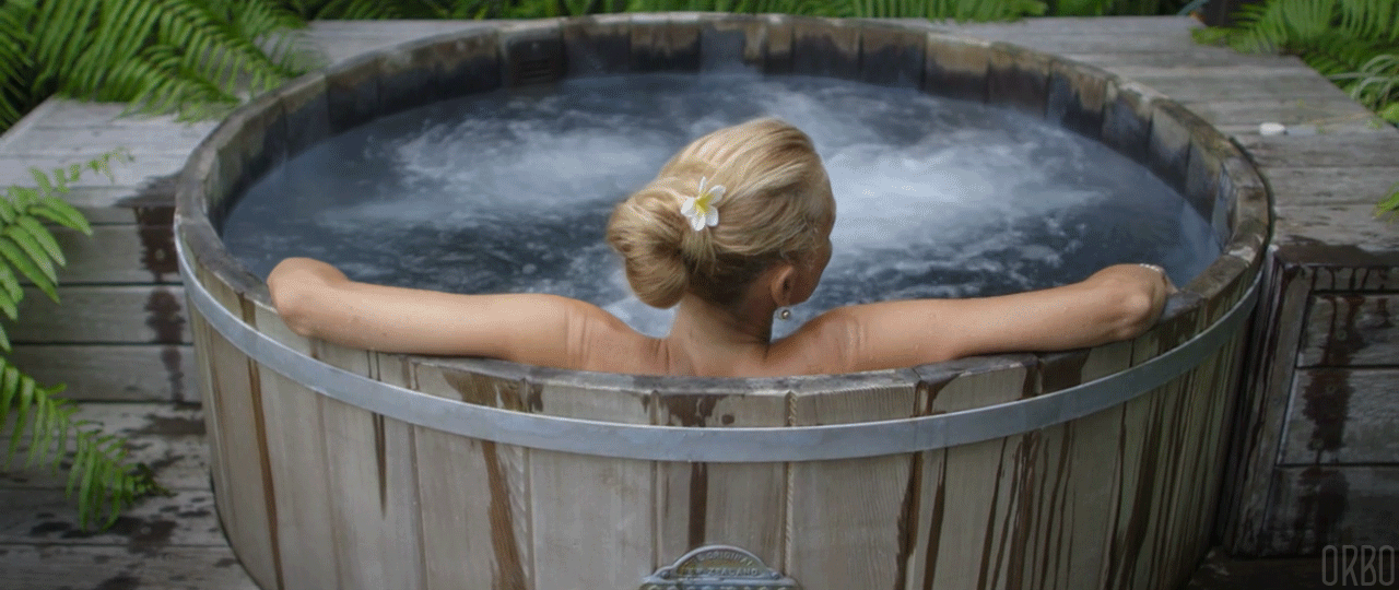 A hot tub sitting on top of a gravel field