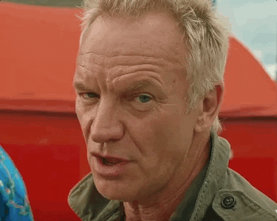Musician Sting winking