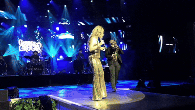 woman wearing yellow long-sleeved dress under white clouds and blue sky during daytime