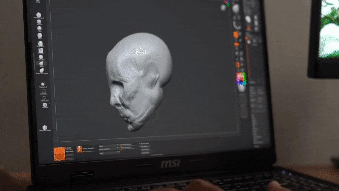 a green sculpture of a man's head on a table