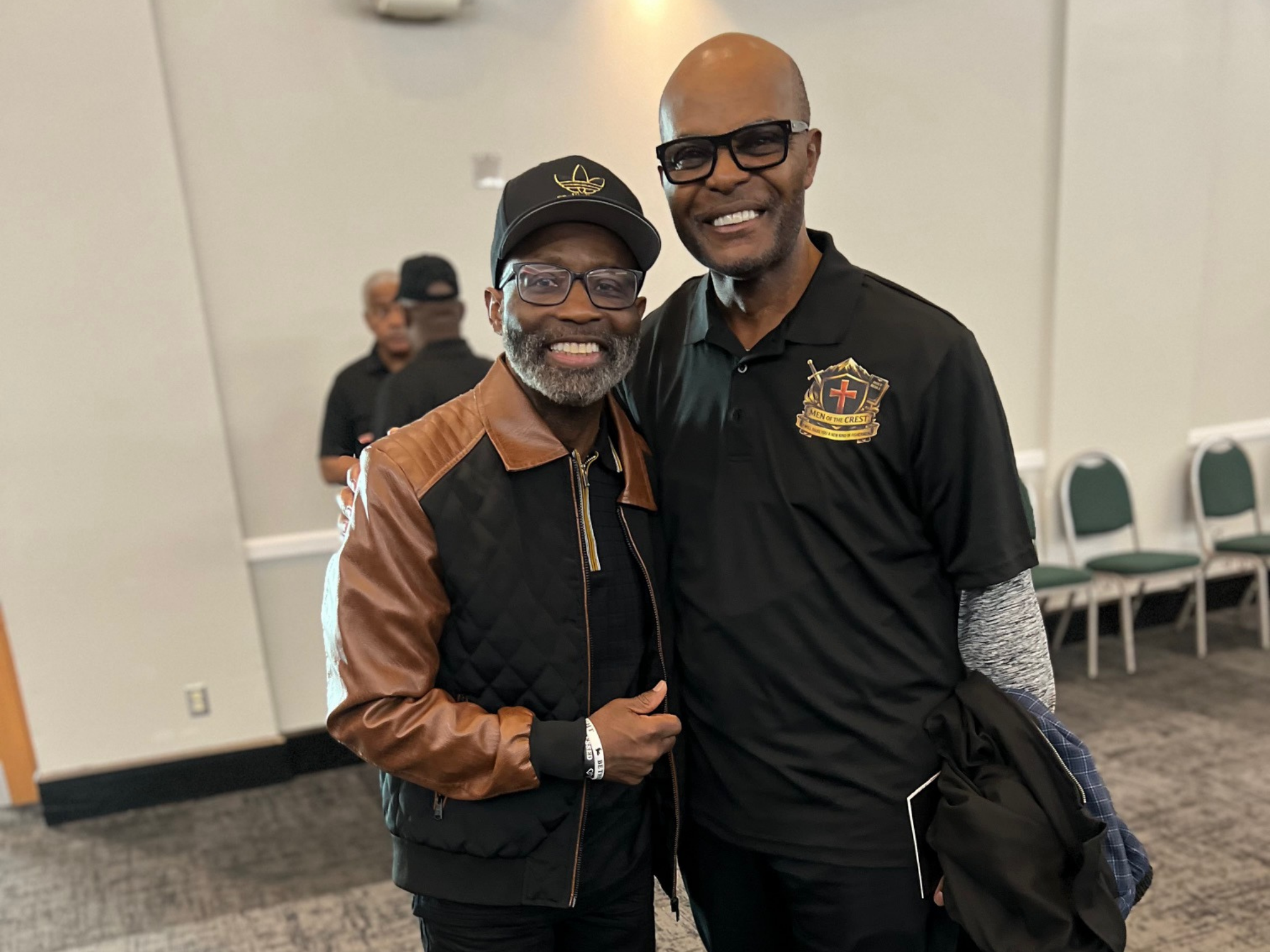 Two men smiling together in the conference room