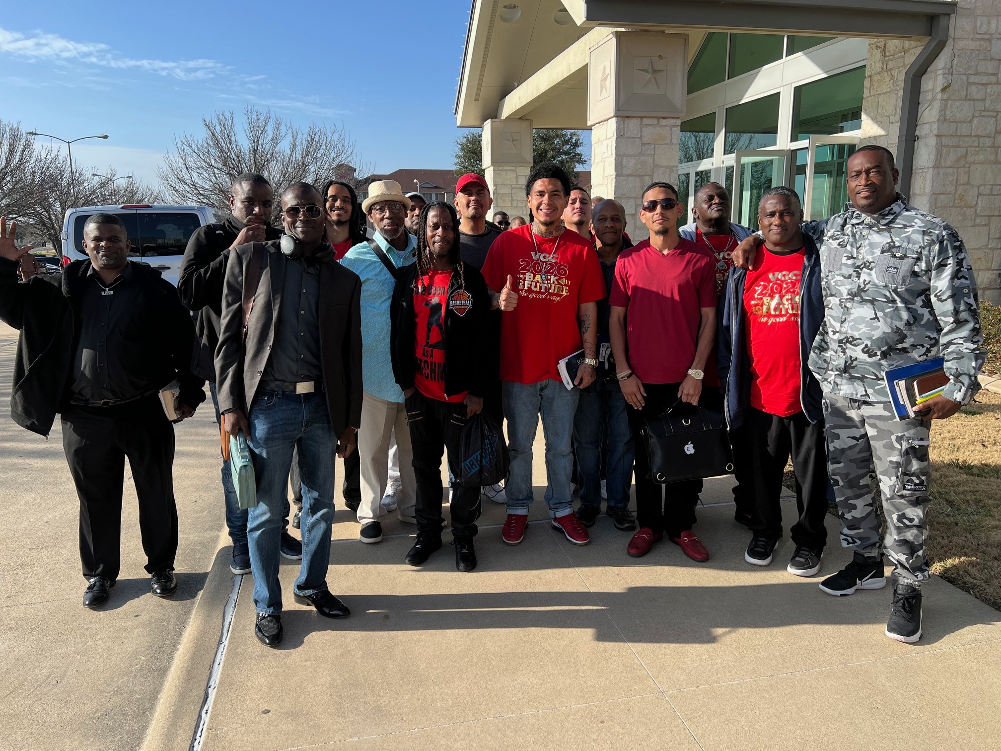 Large group photo outside the building entrance
