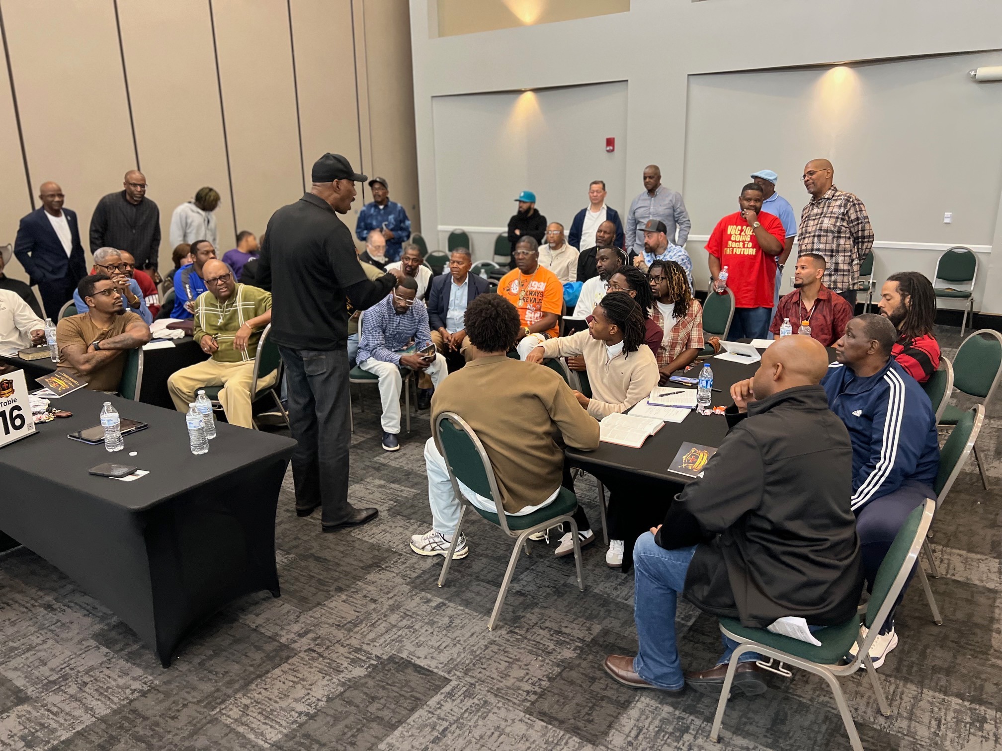 Large group in discussion at tables during the event