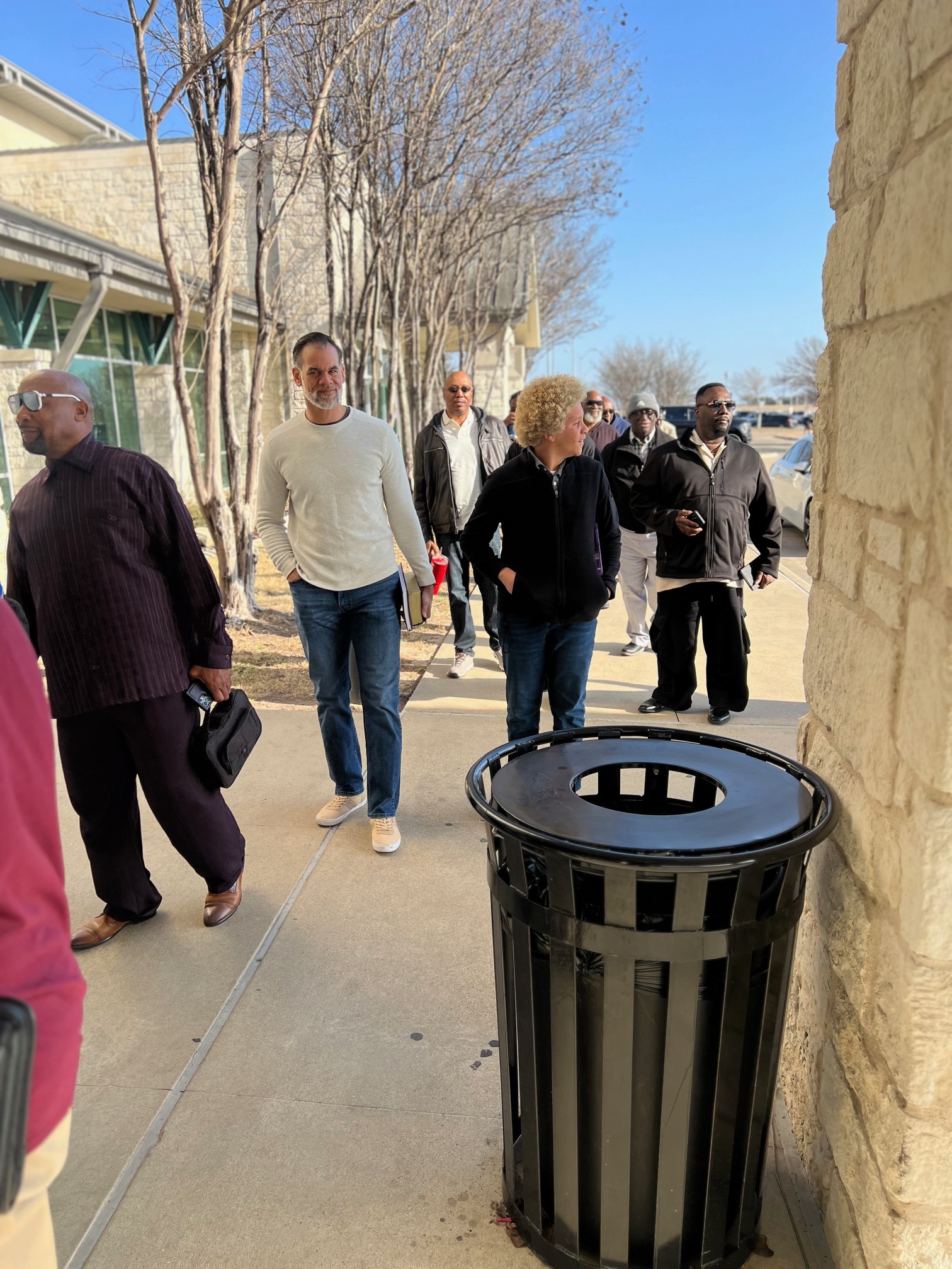 Group of men walking and talking outside the venue
