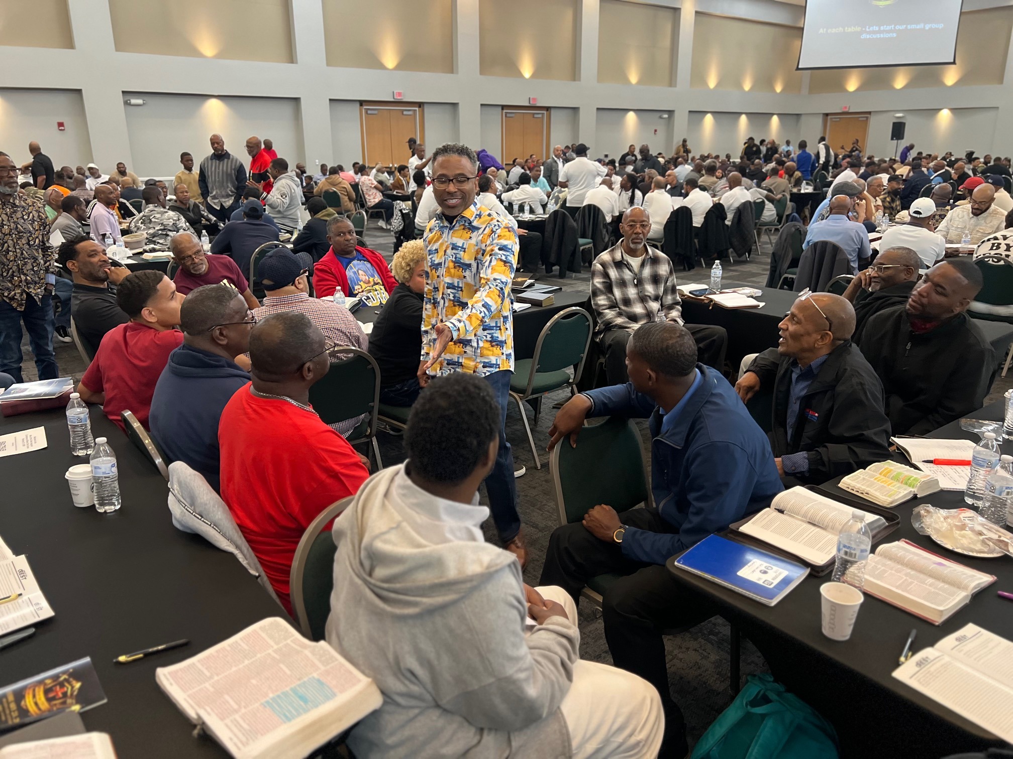 Man standing and speaking passionately to the audience