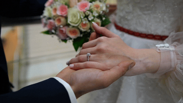 couple wearing silver-colored rings