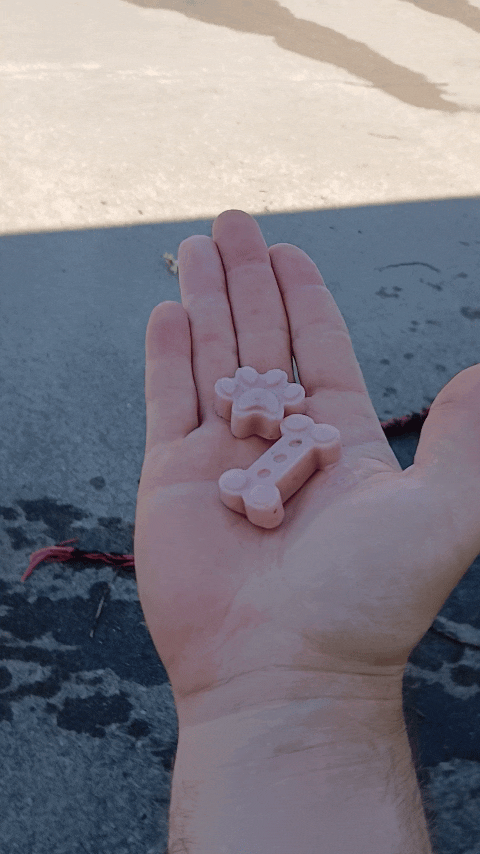 a person holding a teddy bear toy in their hand