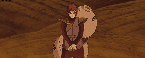 a man in a red outfit standing in the desert