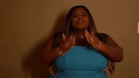 a woman in a blue dress standing in front of a wall jojo todinho