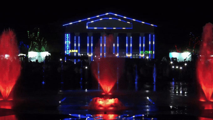 an abstract photo of a curved building with a blue sky in the background