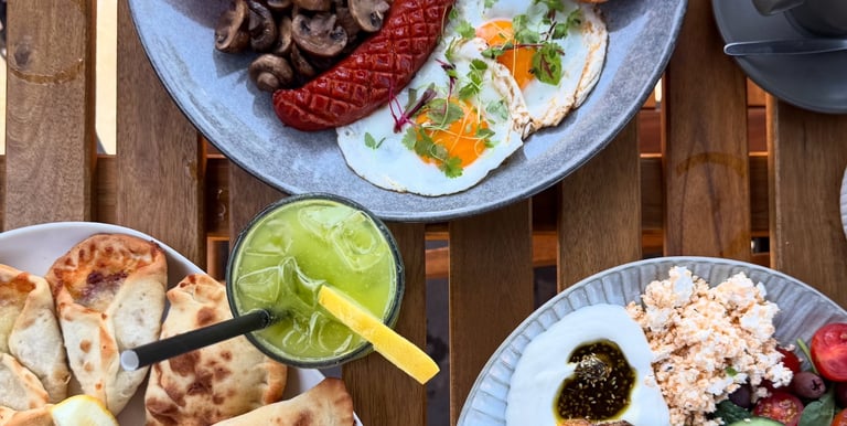 Breakfast plates and iced drink on a table