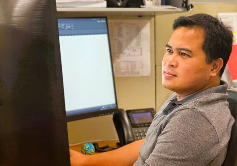 Jeffrey Malicdem at his desk during day-to-day work