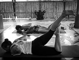 Yoga students practicing a yoga pose.