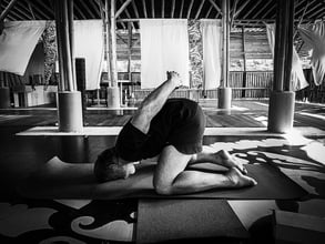 A practitioners executes a modified version of Yoga Mudra