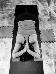 person practising breath-led movement to ease back pain