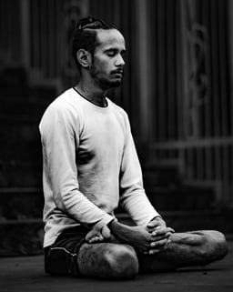 A man meditates in lotus pose