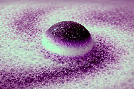 Extra large bath bomb with deep purple center surrounded by foamy lavender fizz.