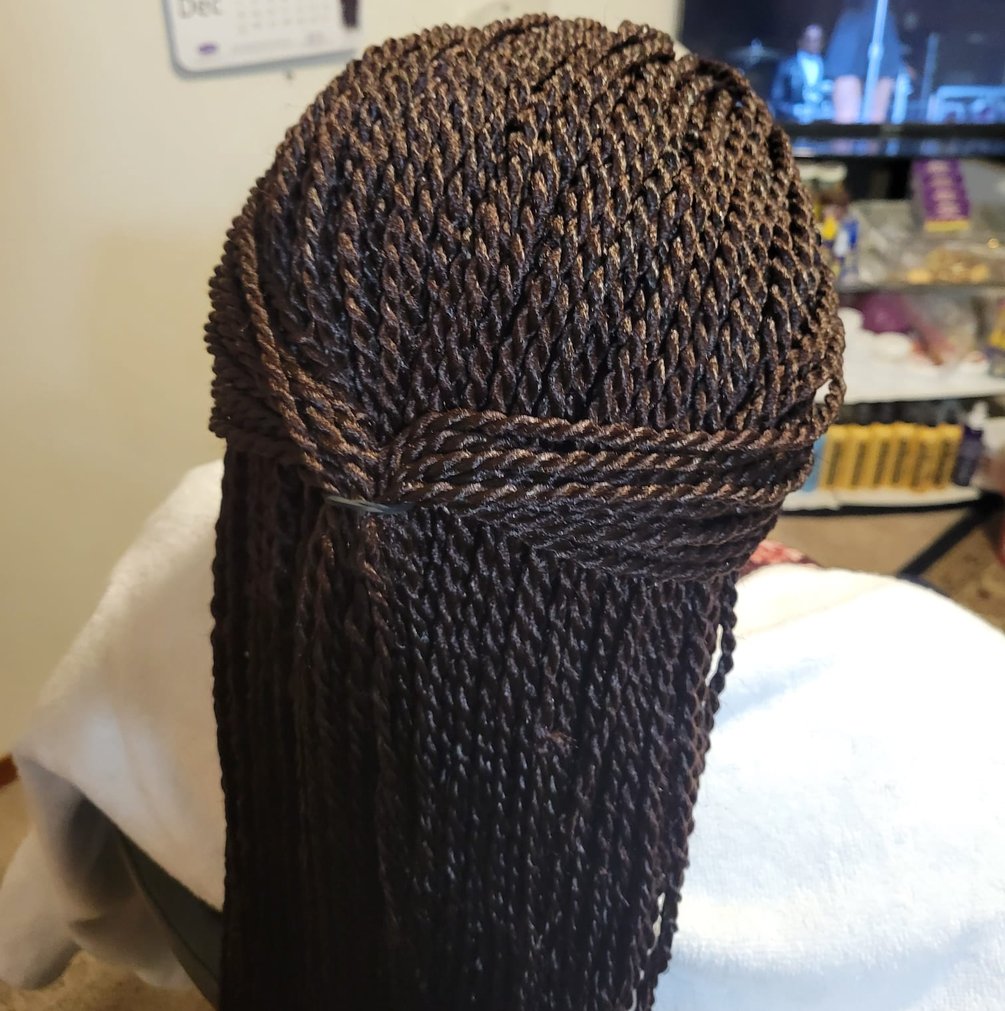 a woman with a large braid braid hair style