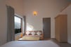 Deluxe Balcony Room with Sofa, table and wardrobe