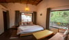 Deluxe room, sofa, bed with greenery view from balcony and side window