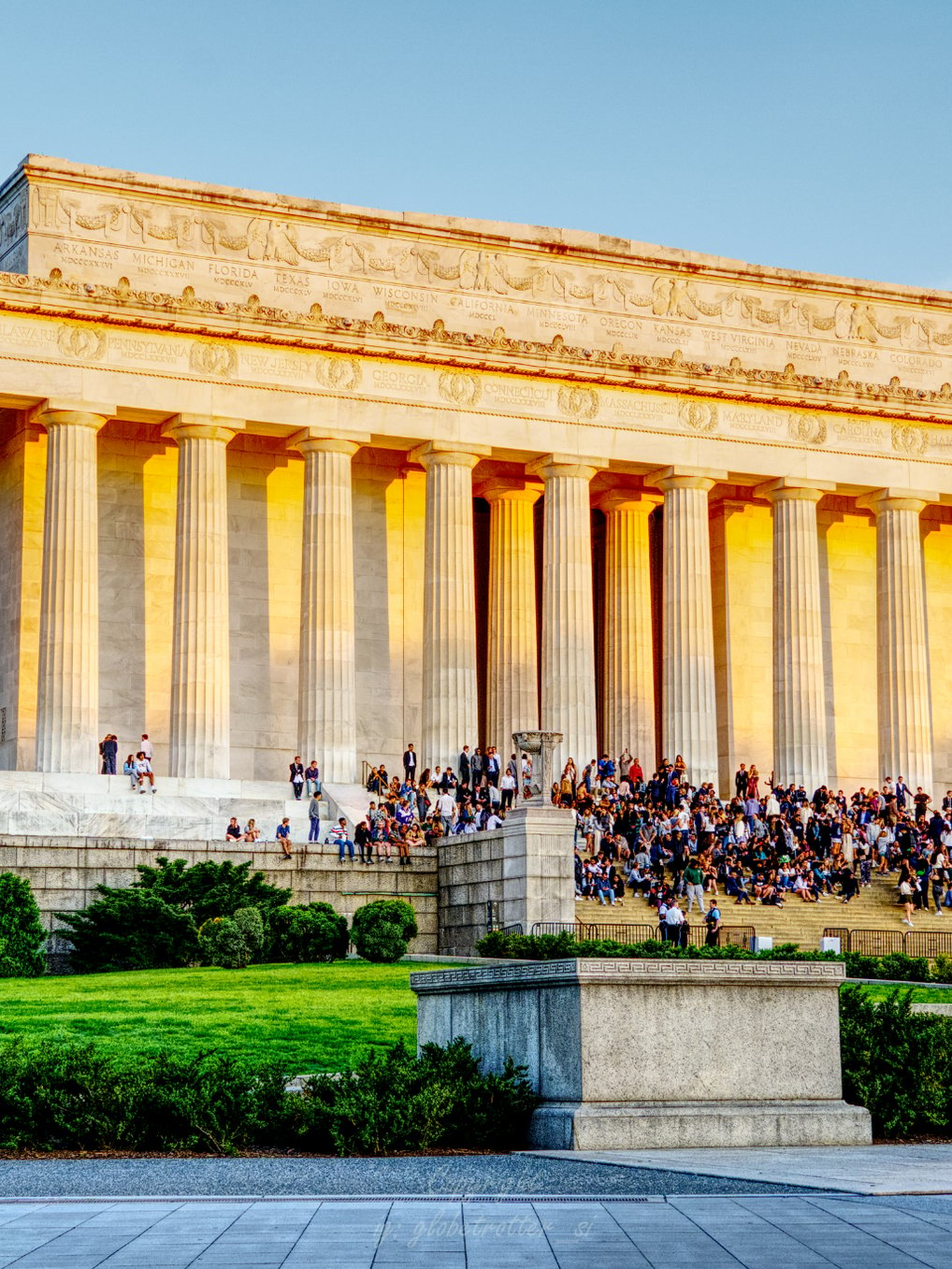 a large building with a lot of people walking up the stairs