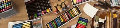 a table with a variety of art supplies and supplies