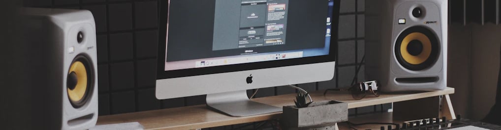 a computer monitor monitor and speakers in a room