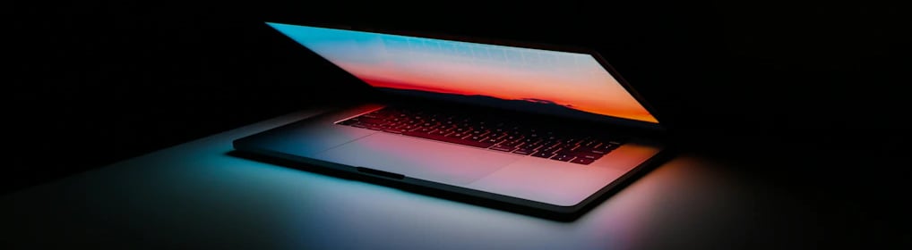 a laptop computer sitting on a table with a laptop