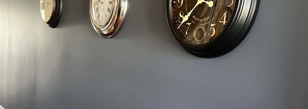 a wall with three clocks