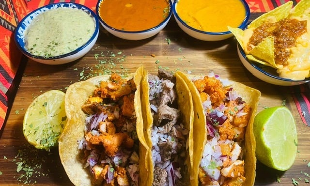 a table with a variety of tasty tasty tacos