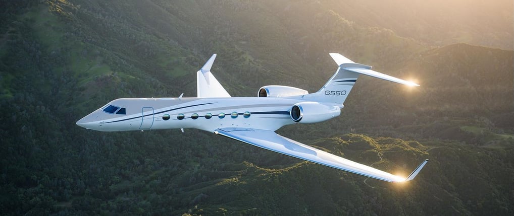 Gulfstream 550 aircraft picture flying over mountains.