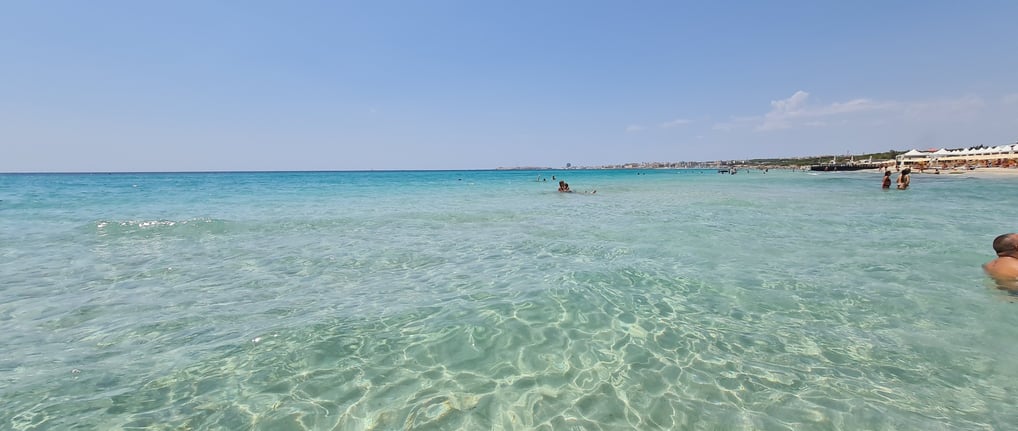 Torre San Giovanni Beach, Puglia – A long stretch of golden sand with calm, shallow waters, perfect 
